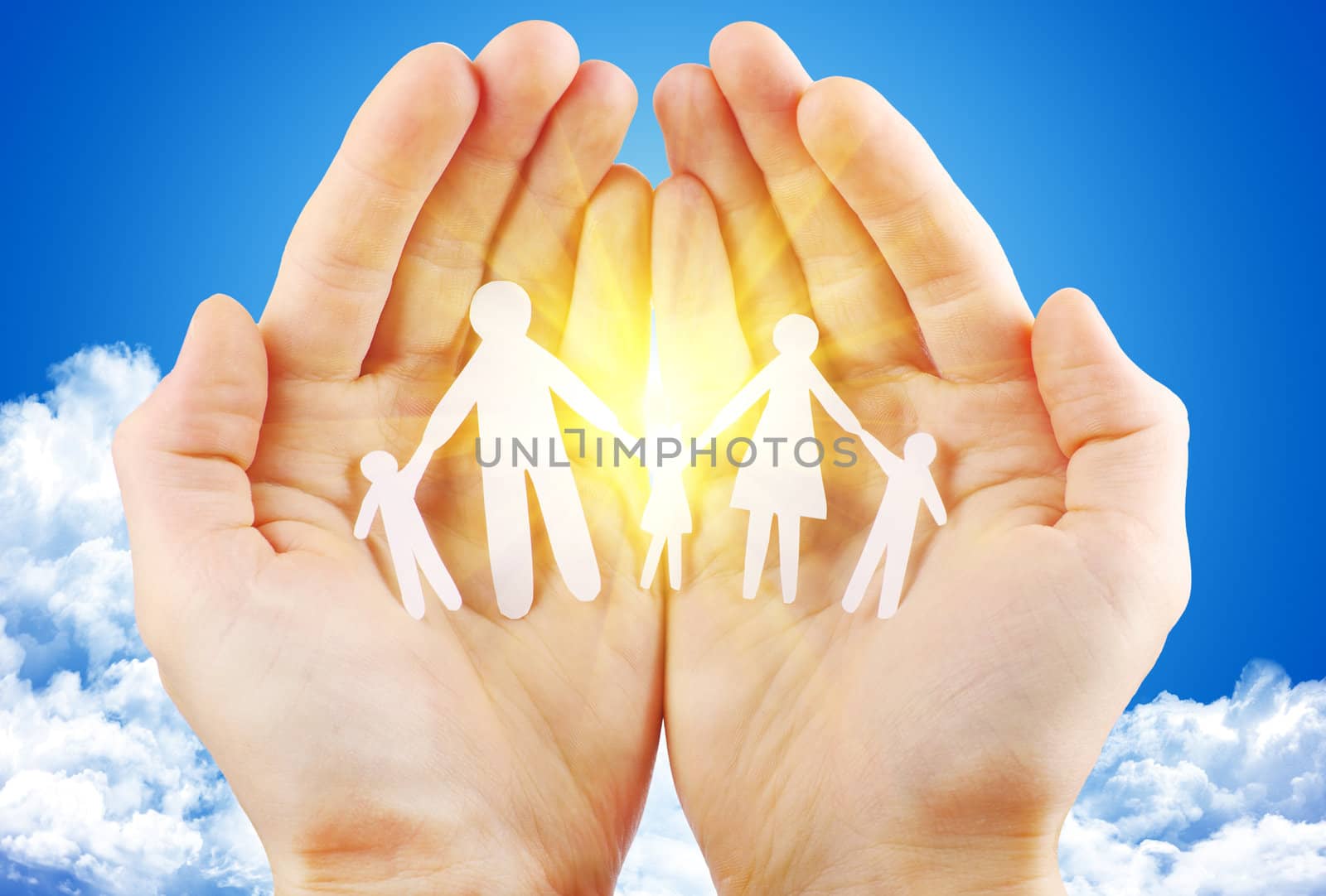paper family in hand sun and blue sky with copyspace showing freedom or solar power concept