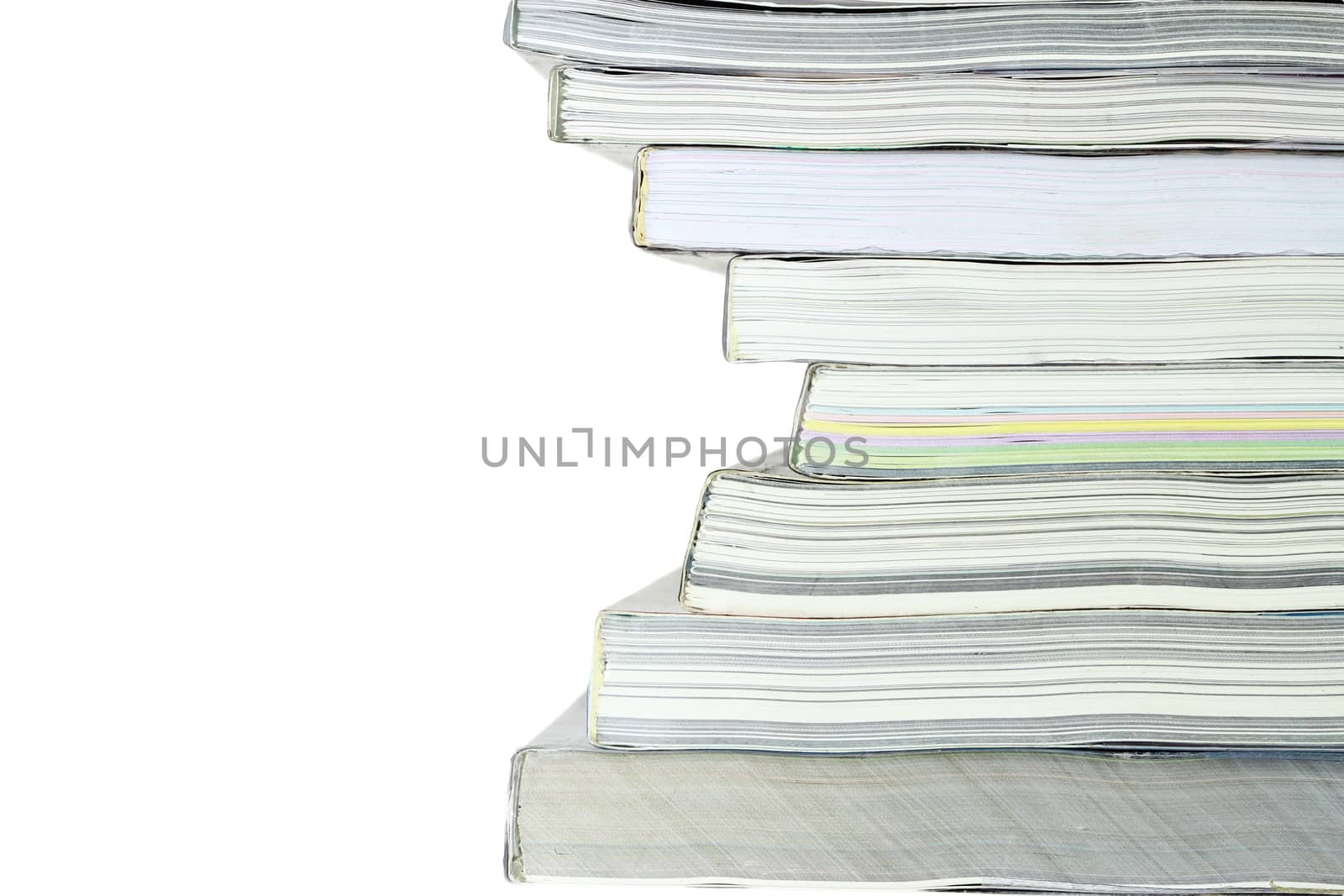 Stack of books on white background, partial view.