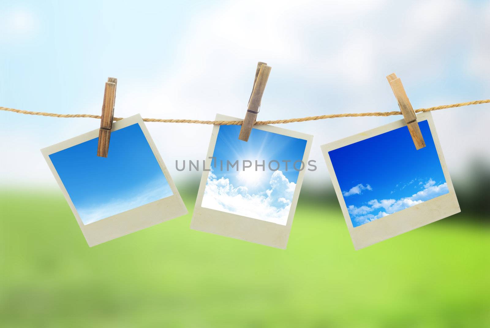 Three instant photos with sky inside hanging on the clothesline