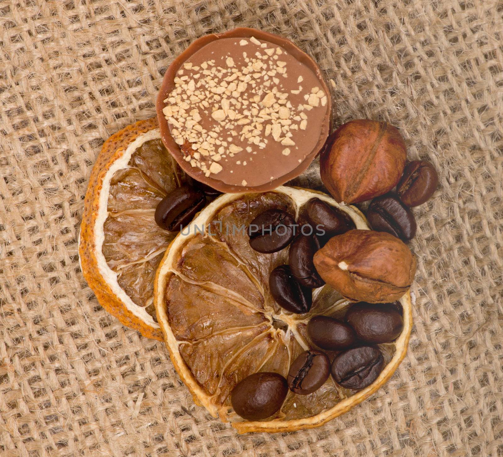 Sweet, lemon, nuts and coffee beans on burlap