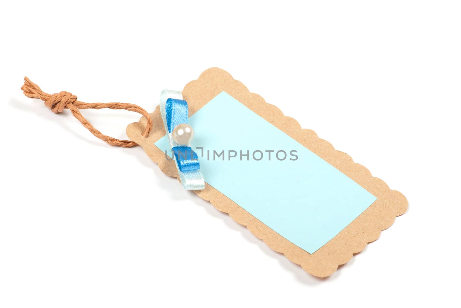 Blank tag tied with brown string. Price tag, gift tag, sale tag, address label, etc.