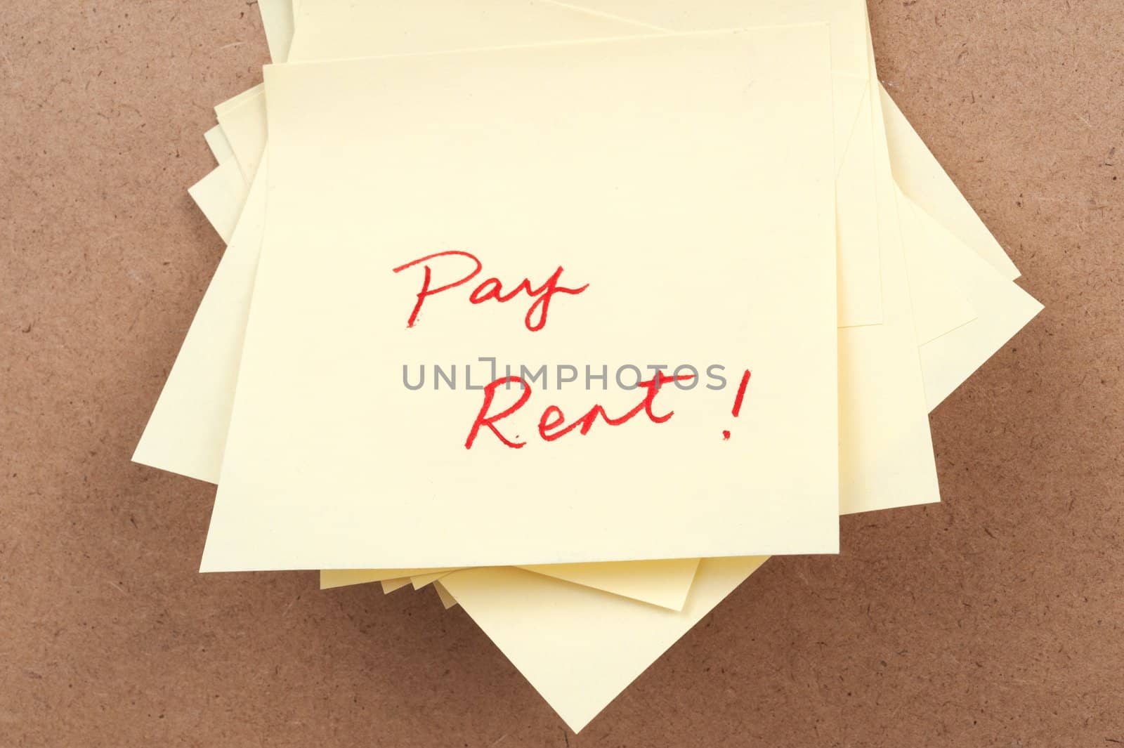 Pay rent words written on sticky note