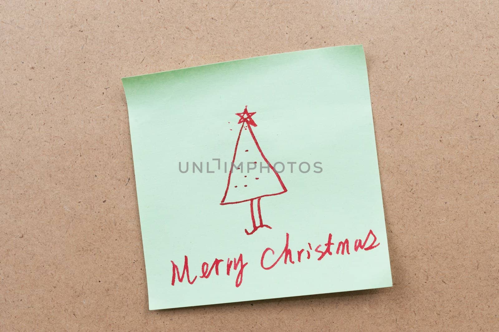 Merry Christmas words written on a sticky note