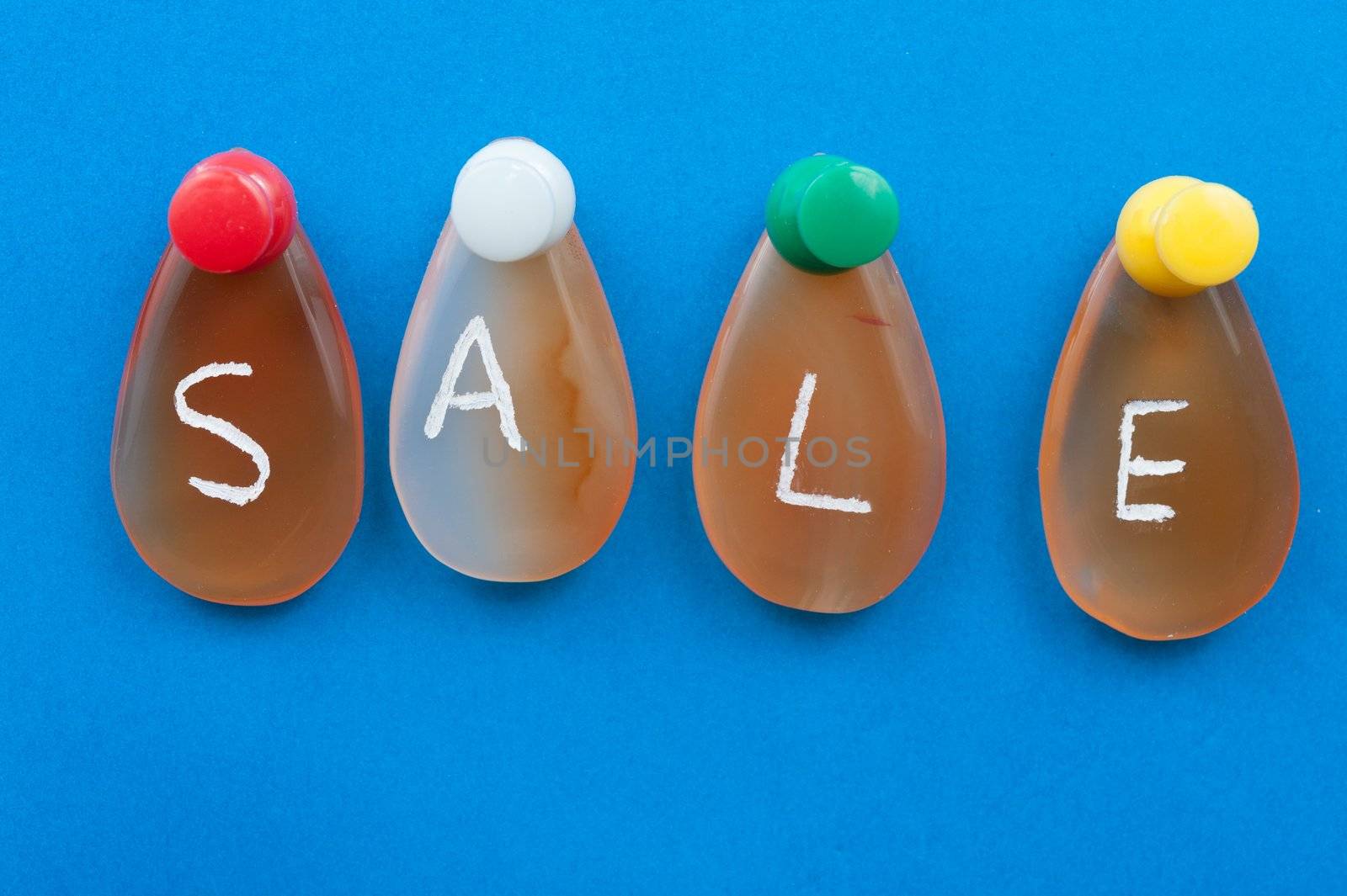 Sale word spelled with agates pinned on the board