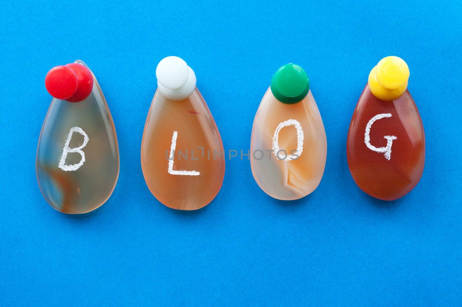 Blog word spelled with agates pinned on the board