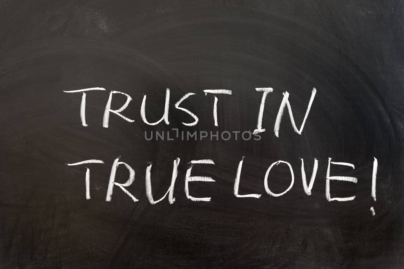 Trust in true love words written on the blackboard