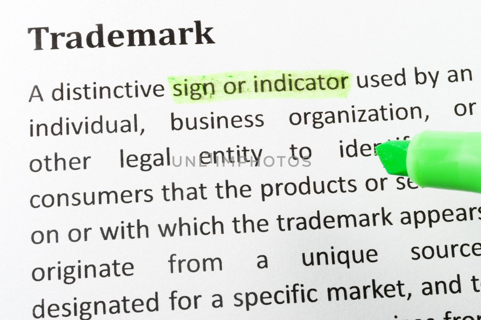 Highlighter and trademark concept words on paper