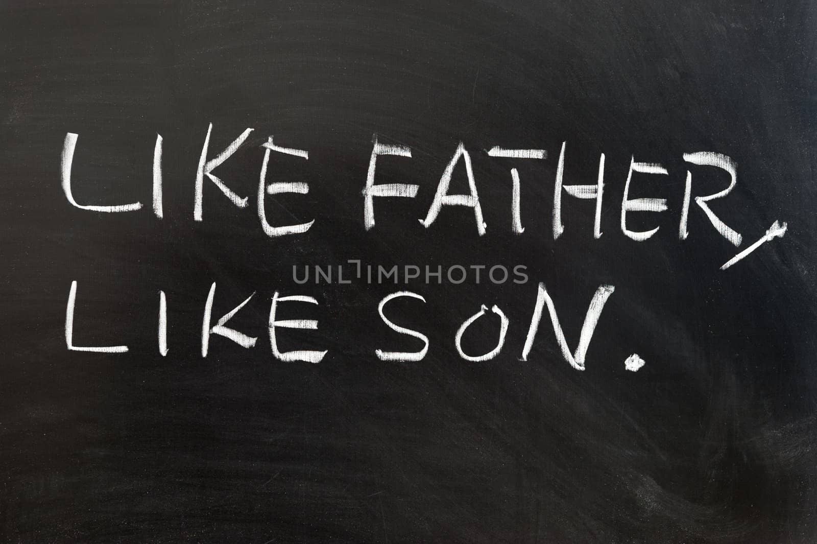 Saying of "Like father, like son" written on the blackboard