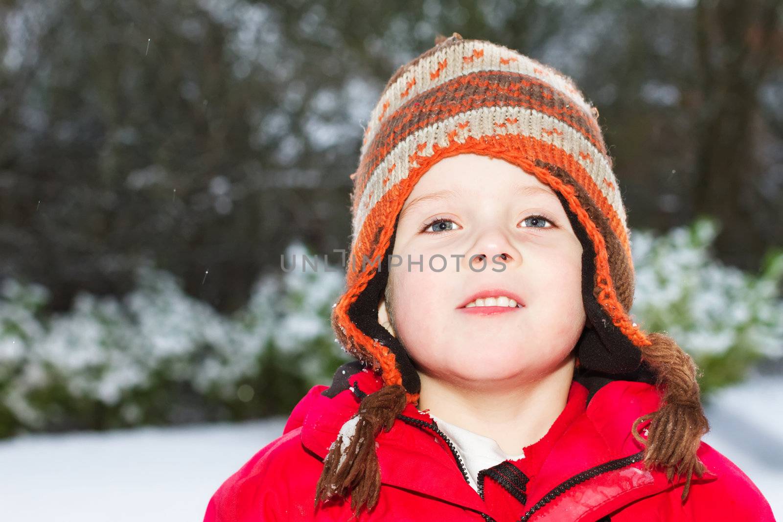 young boy smiling in the snow