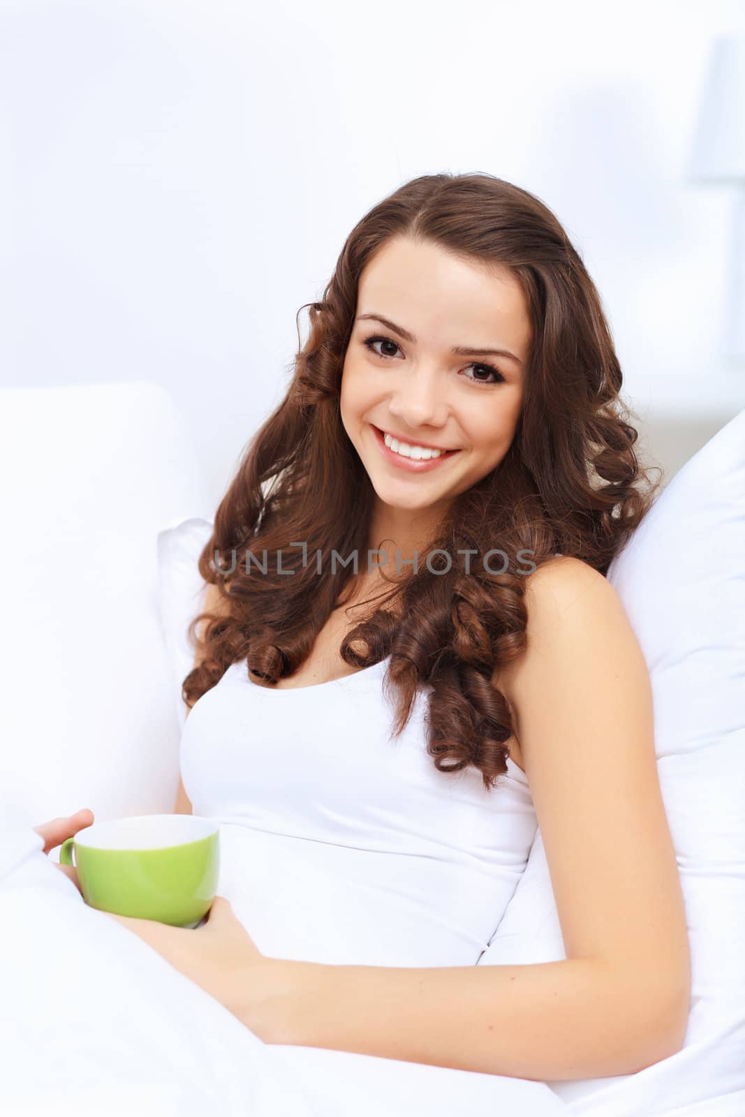 Portrait of lovely young woman having cup of tea at home