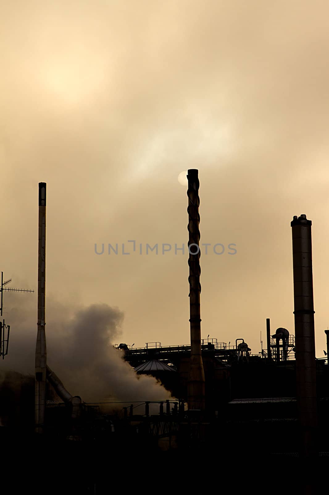 silhouette of an industrial premises with steam billowing out