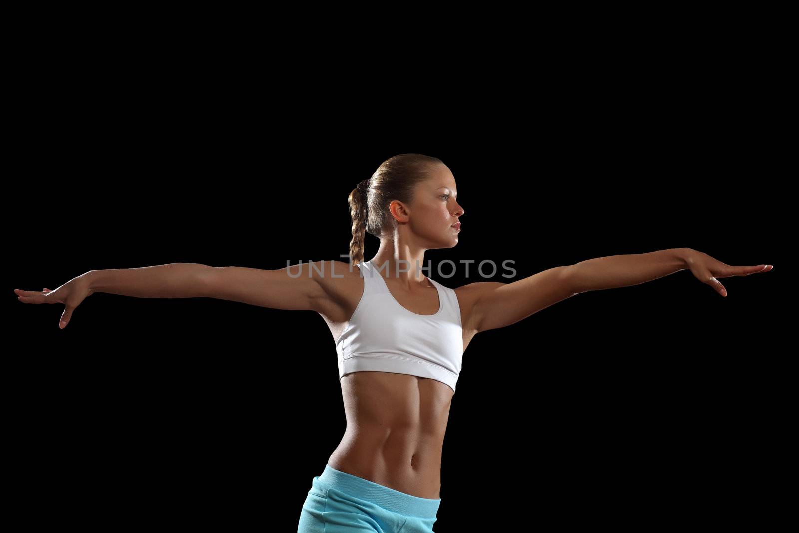 Fitness woman smiling standing against black background