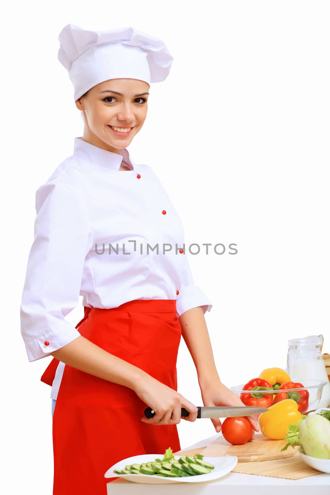 Young cook preparing food wearing red apron