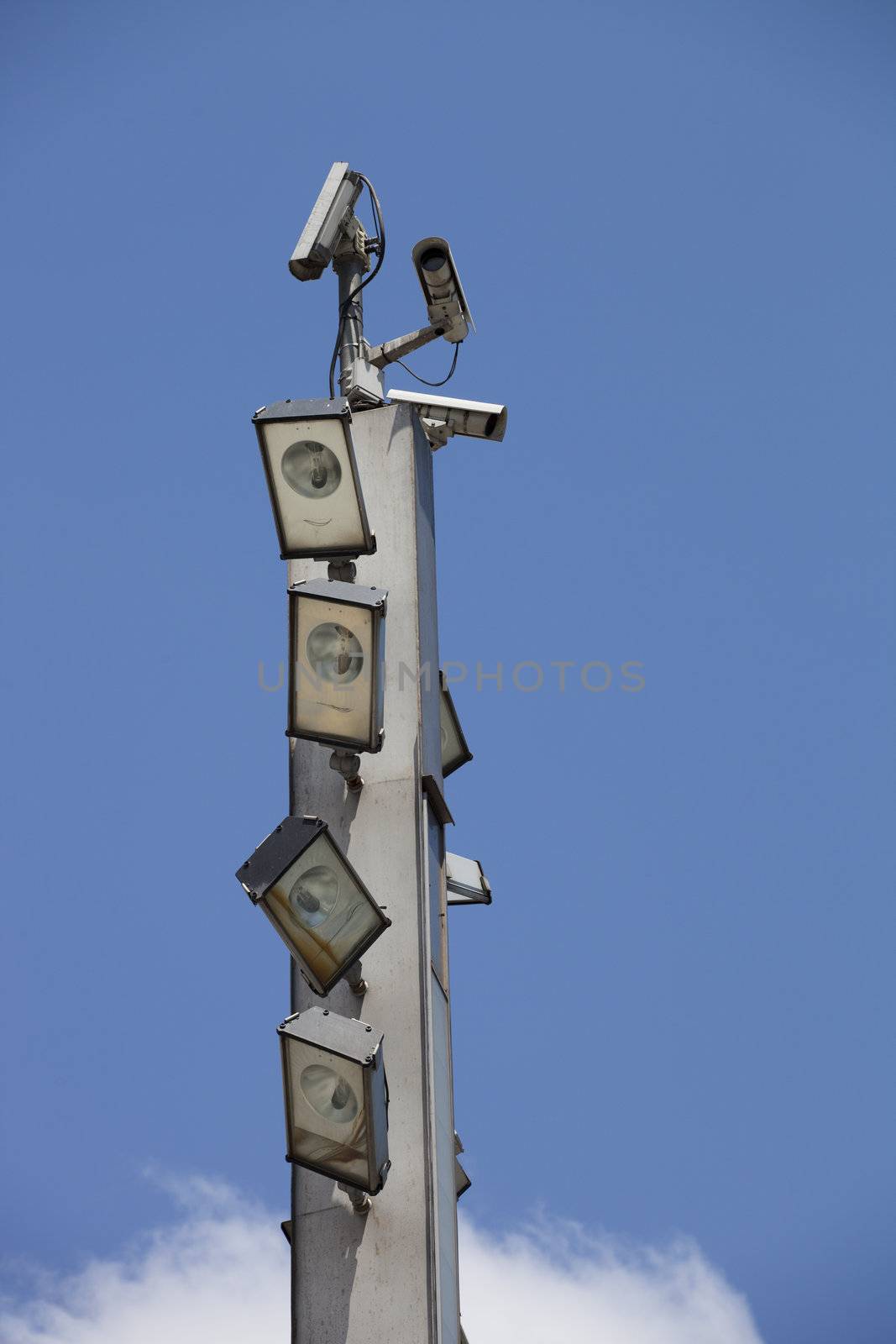 Surveillance cameras and floodlights on top of the pole