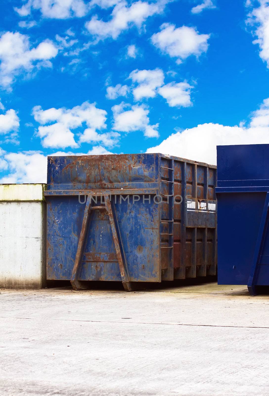 recycling centre waste bin with a cloudy blue  sky