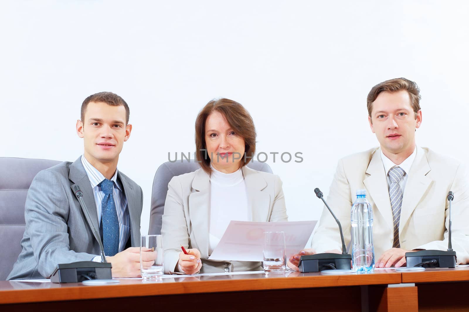 Three businesspeople at meeting by sergey_nivens