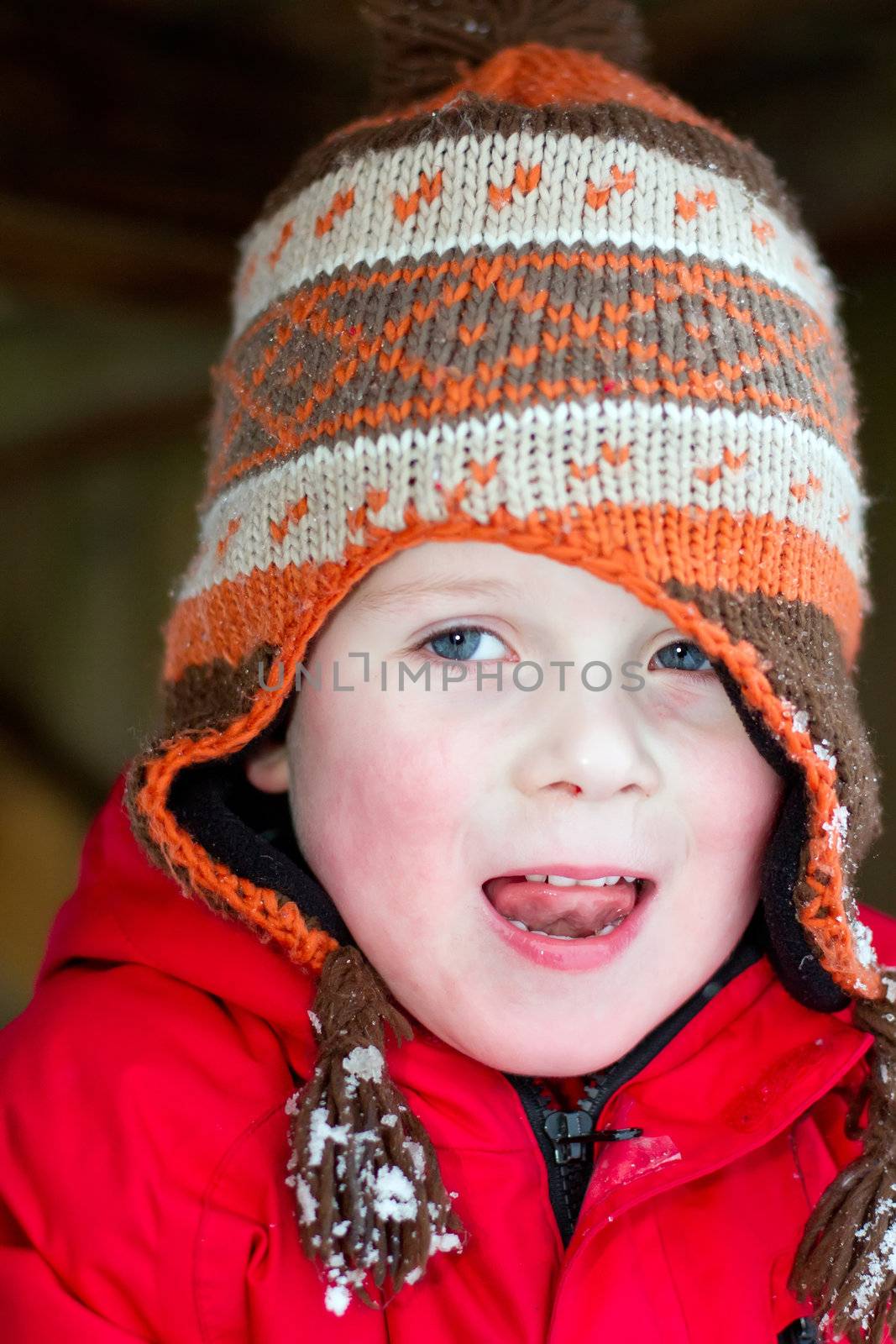 young boy smiling in the snow