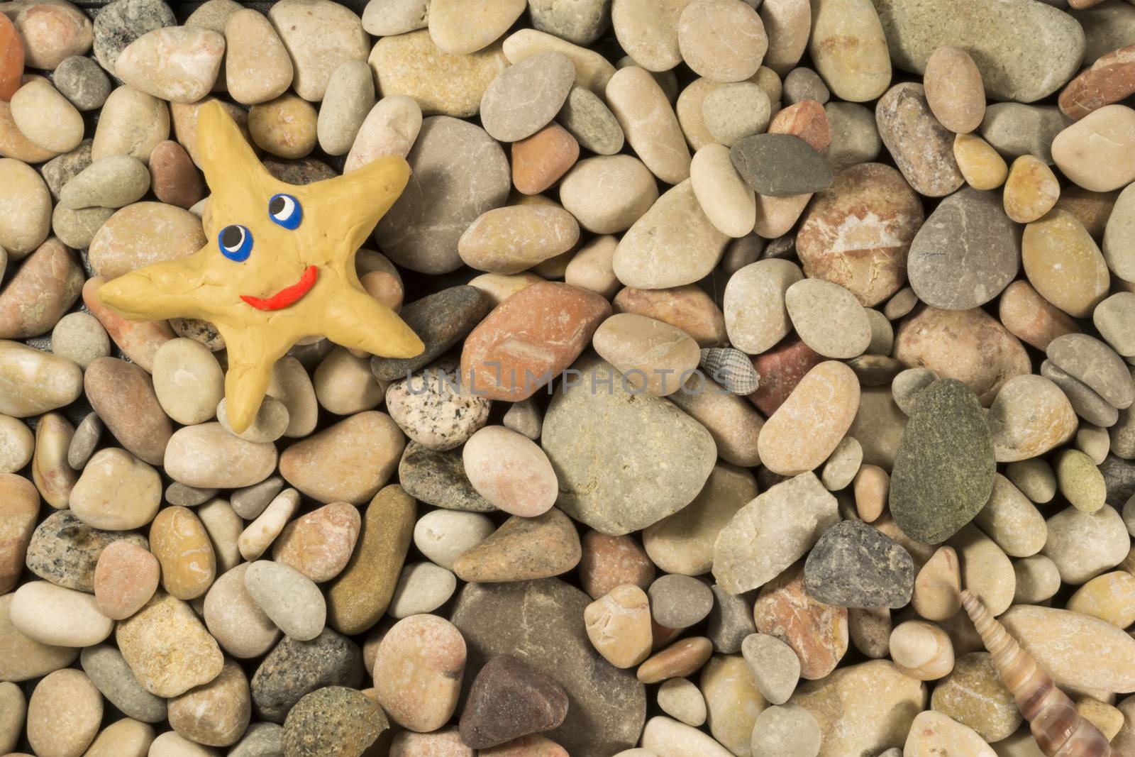 The background image of the marine pebbles with a plasticine star in the upper left corner.