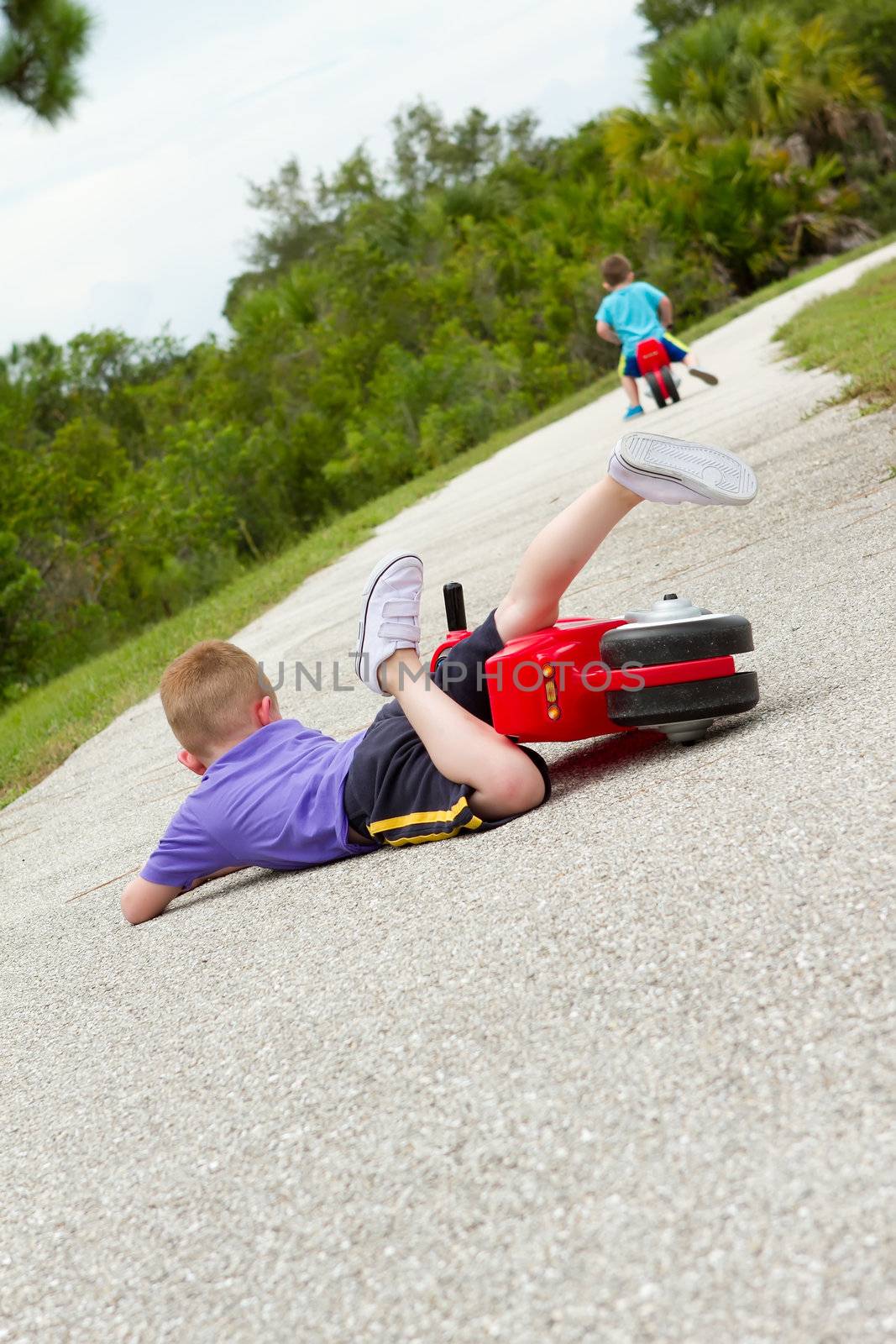 little boy fallen off of his bike