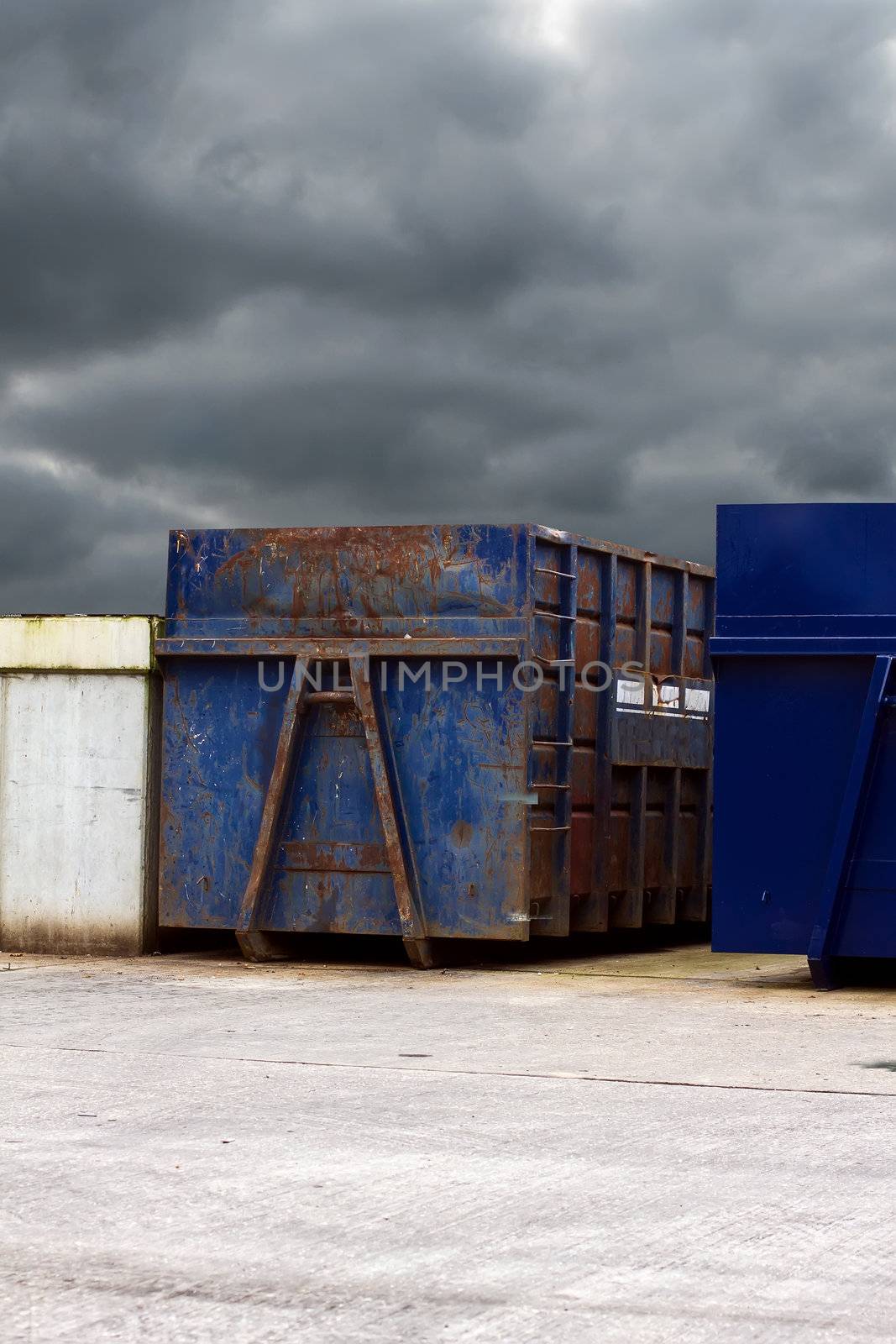 recycling centre waste bin with a cloudy grey sky