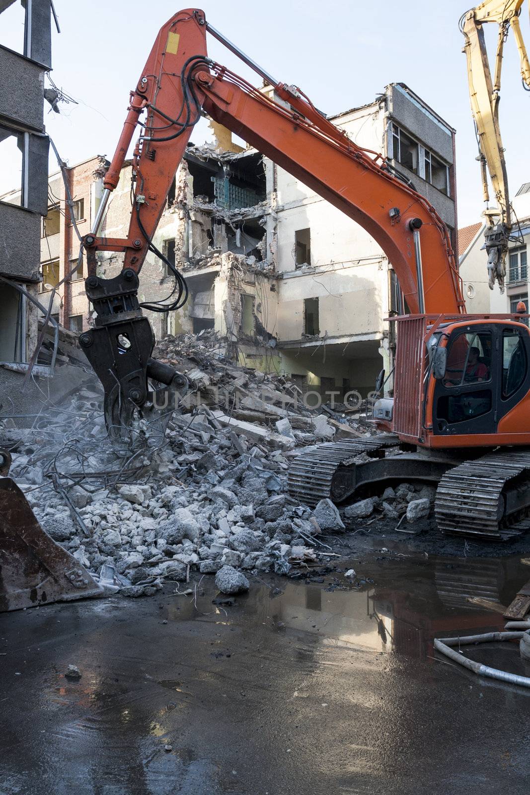 Demolition of an old building with heavy machinery for new construction