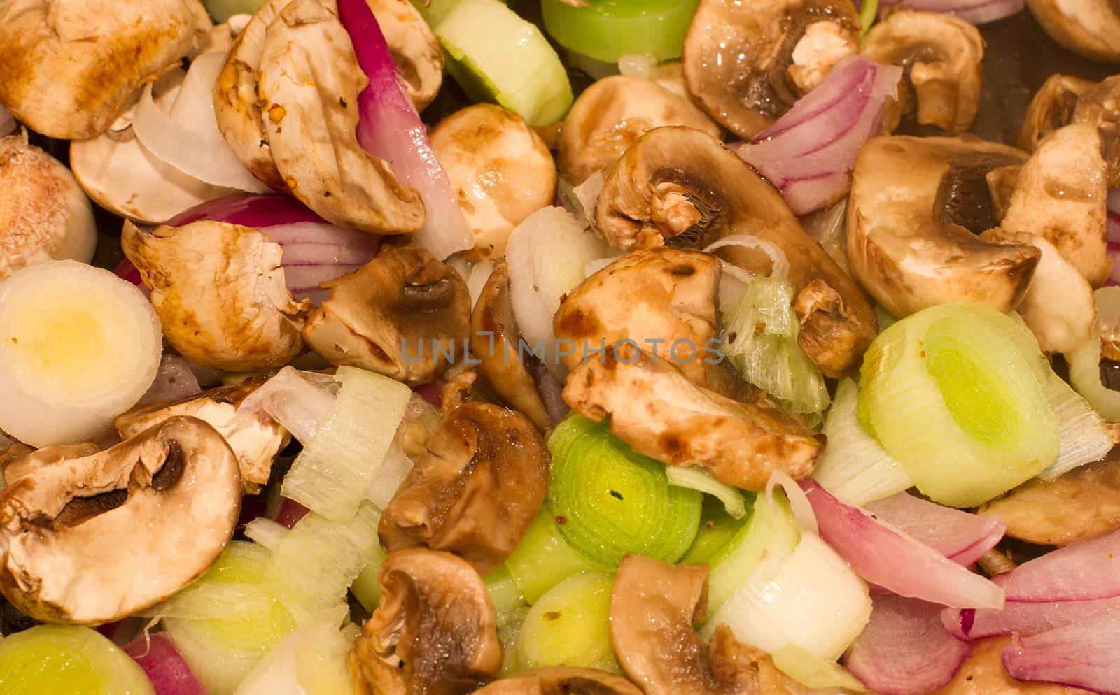 Mushrooms, Leeks and red onions frying in a pan