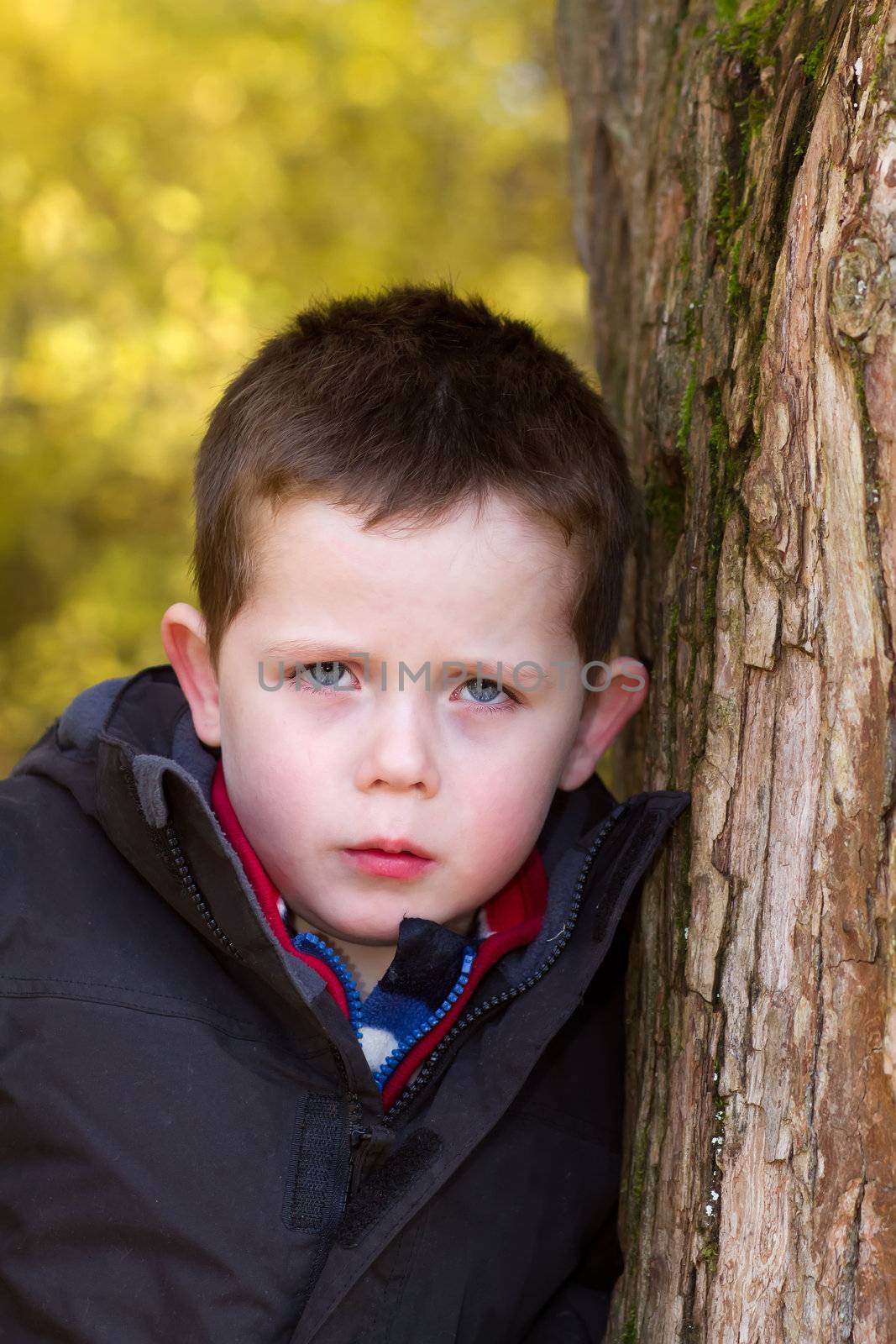 sad little boy looking straight ahead