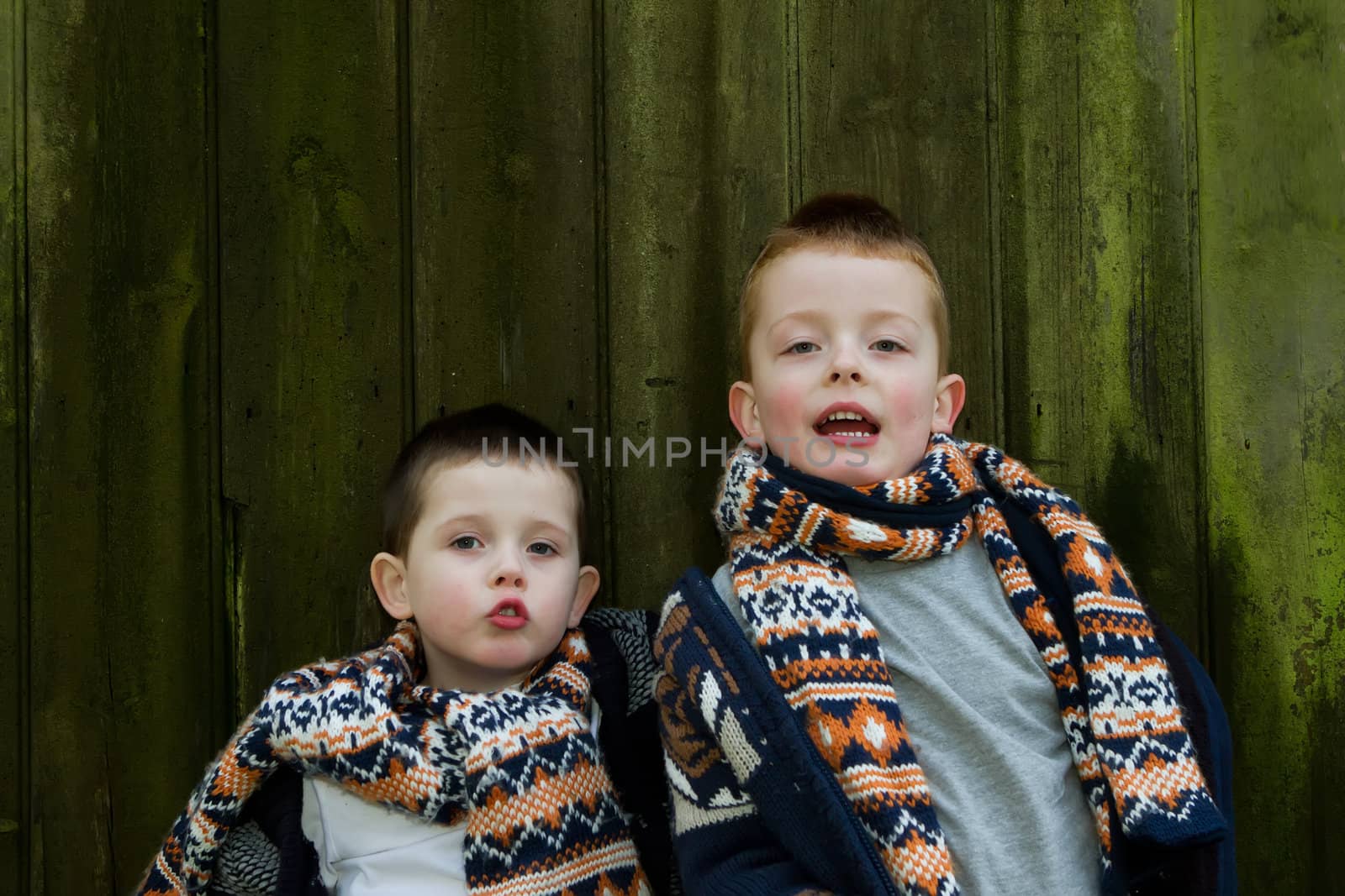 brothers outside by a old wooden hut