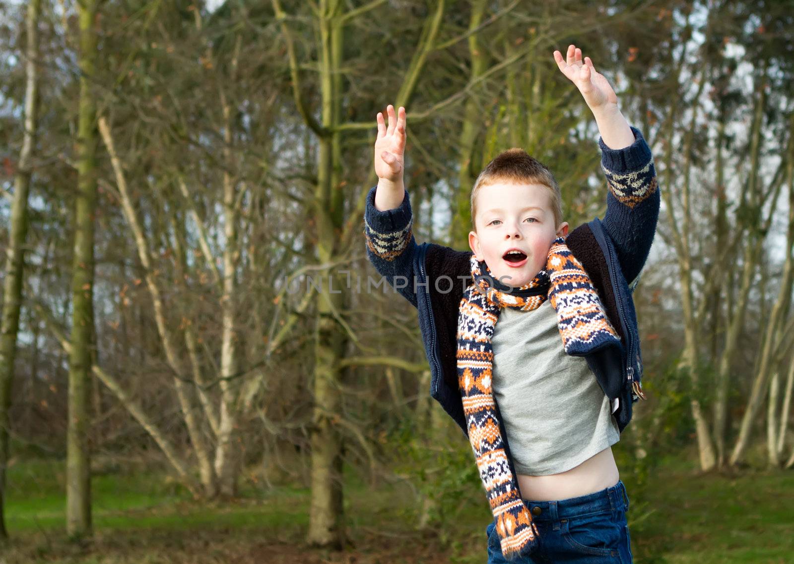 little boy jumping with joy outdoors in countryside