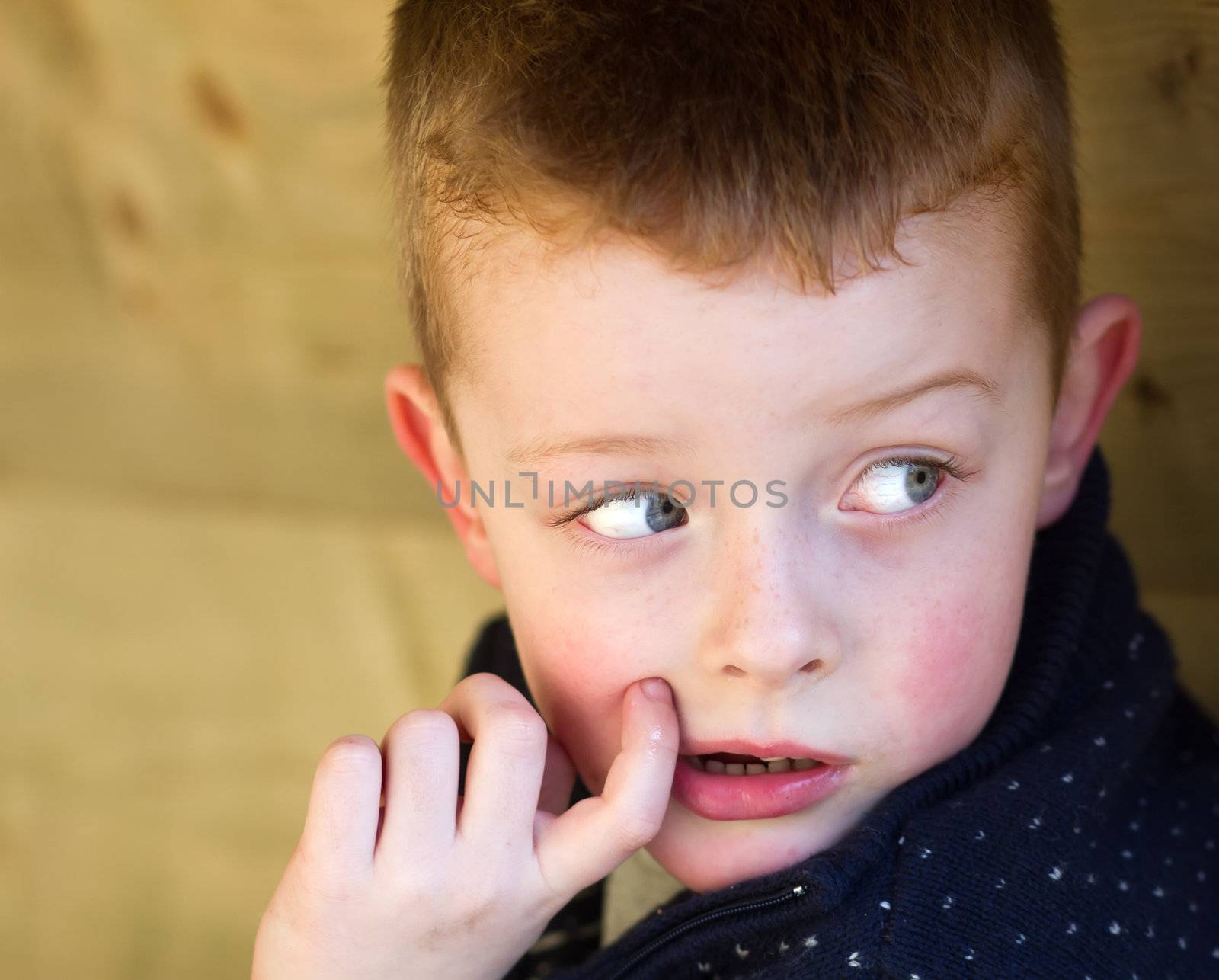 young boy peeping around the corner