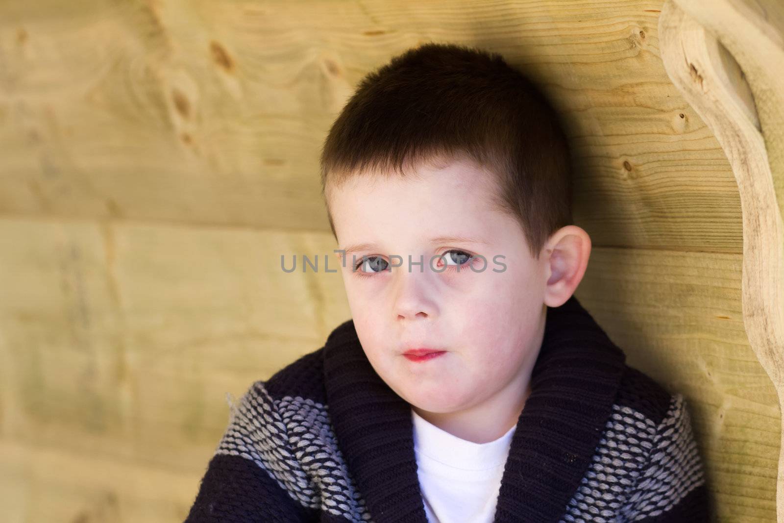 Depressed young boy looking directly ahead