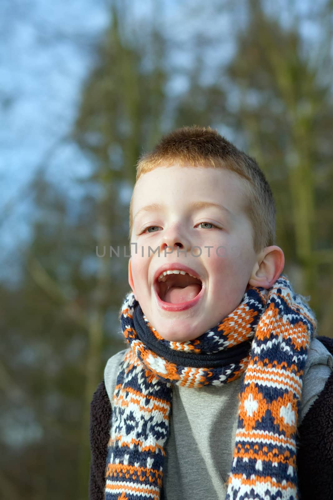 happy young boy playing outdoors