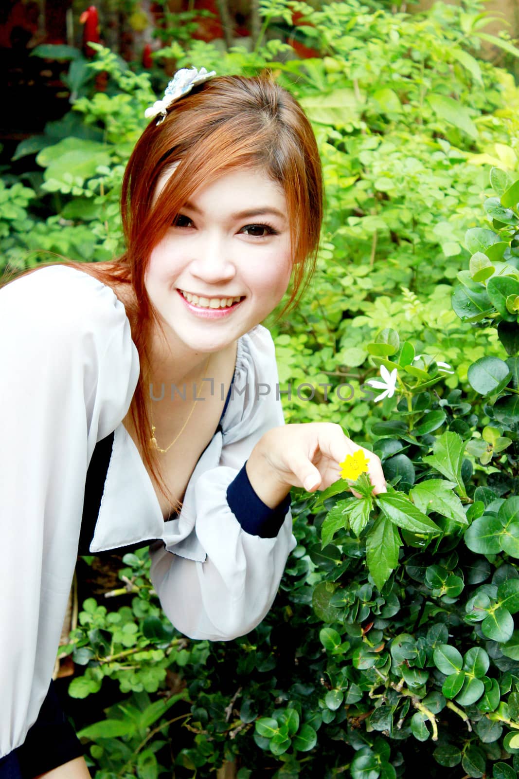 portrait of a beautiful asian woman and small flower