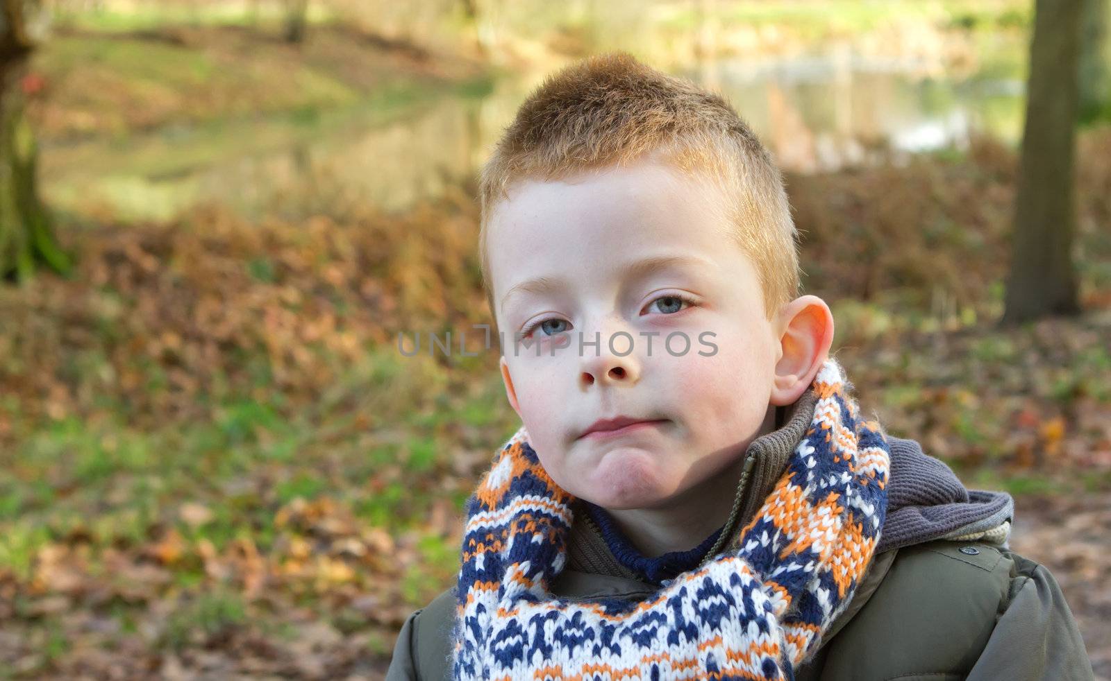 Depressed young boy looking directly ahead