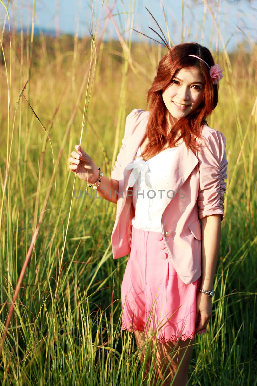 Portrait of beautiful young Asian girl in the grass