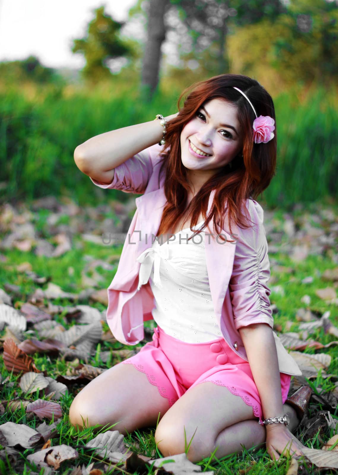 Portrait of beautiful young Asian girl in the grass