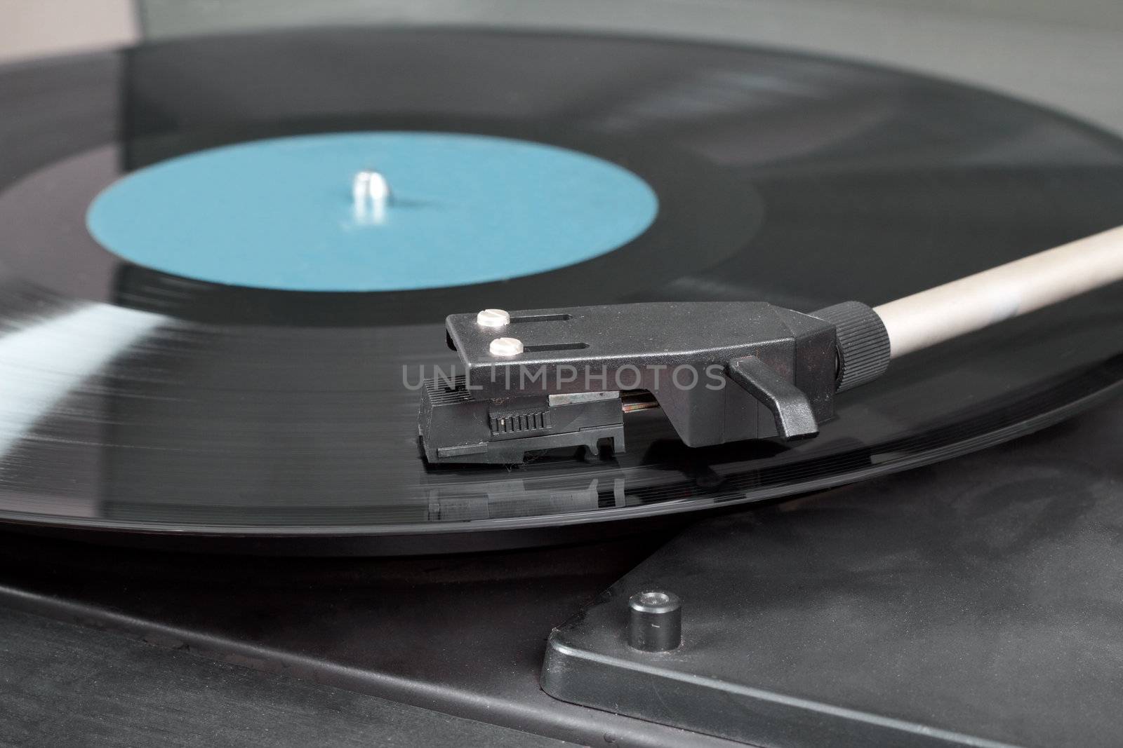 Detail of vintage record player with spinning vinyl. Motion blur image. 