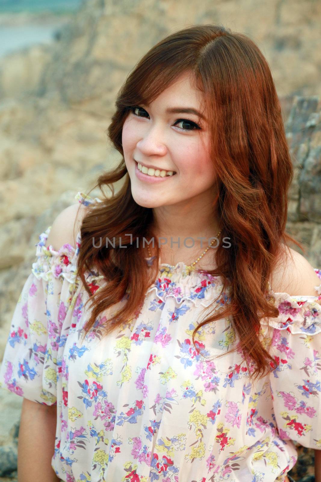 a portrait of beautiful woman with stone background