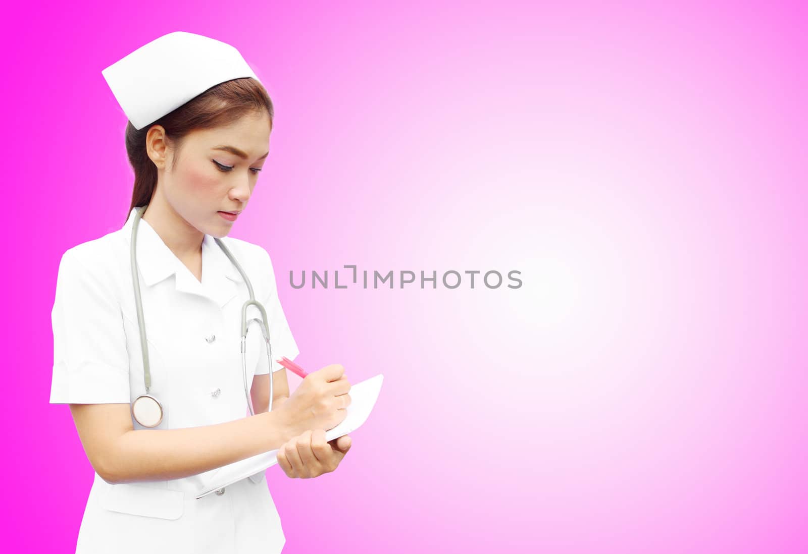 Asian female nurse writing medical report on pink background