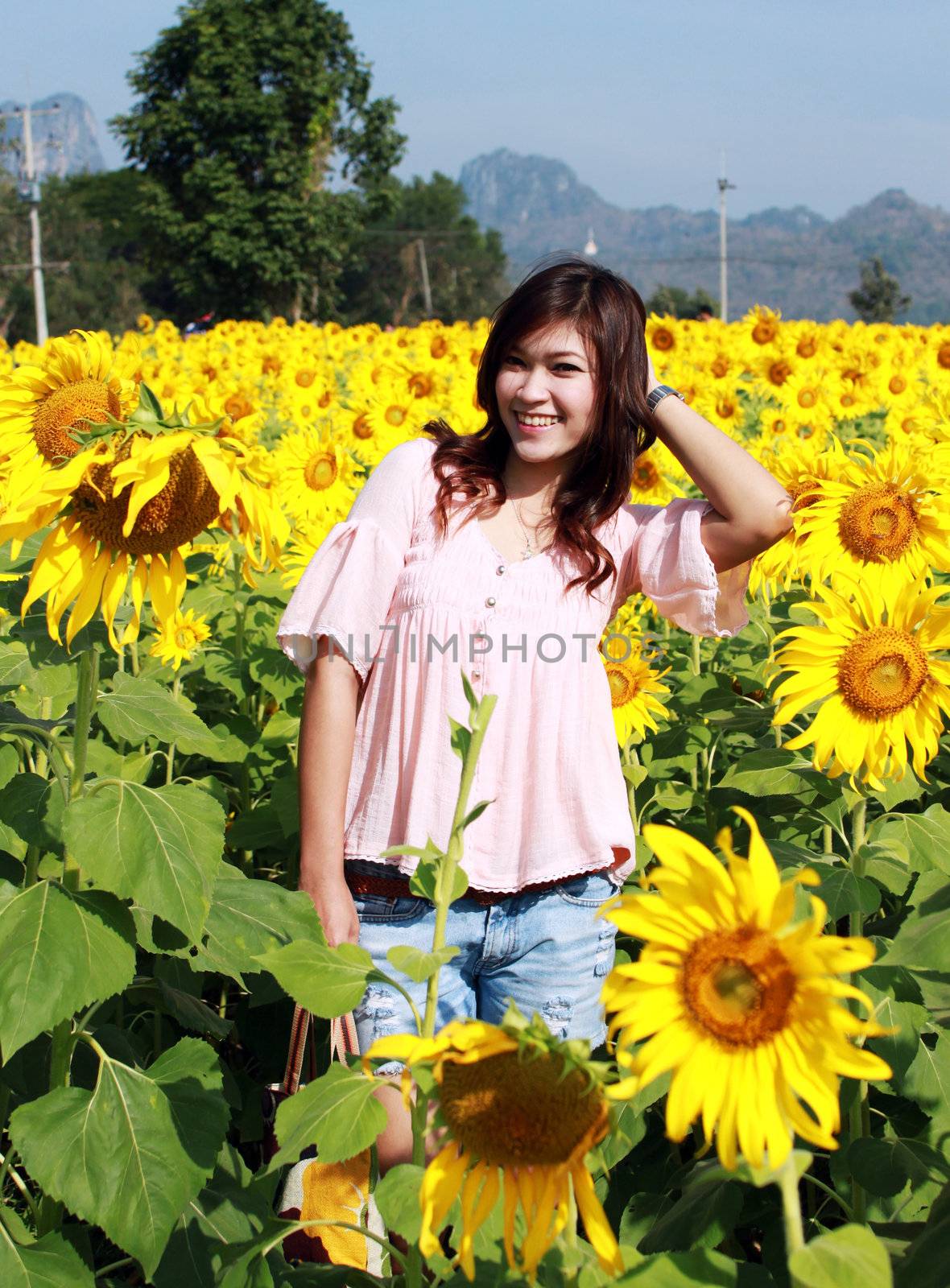 Women in the field of sunflowers by geargodz