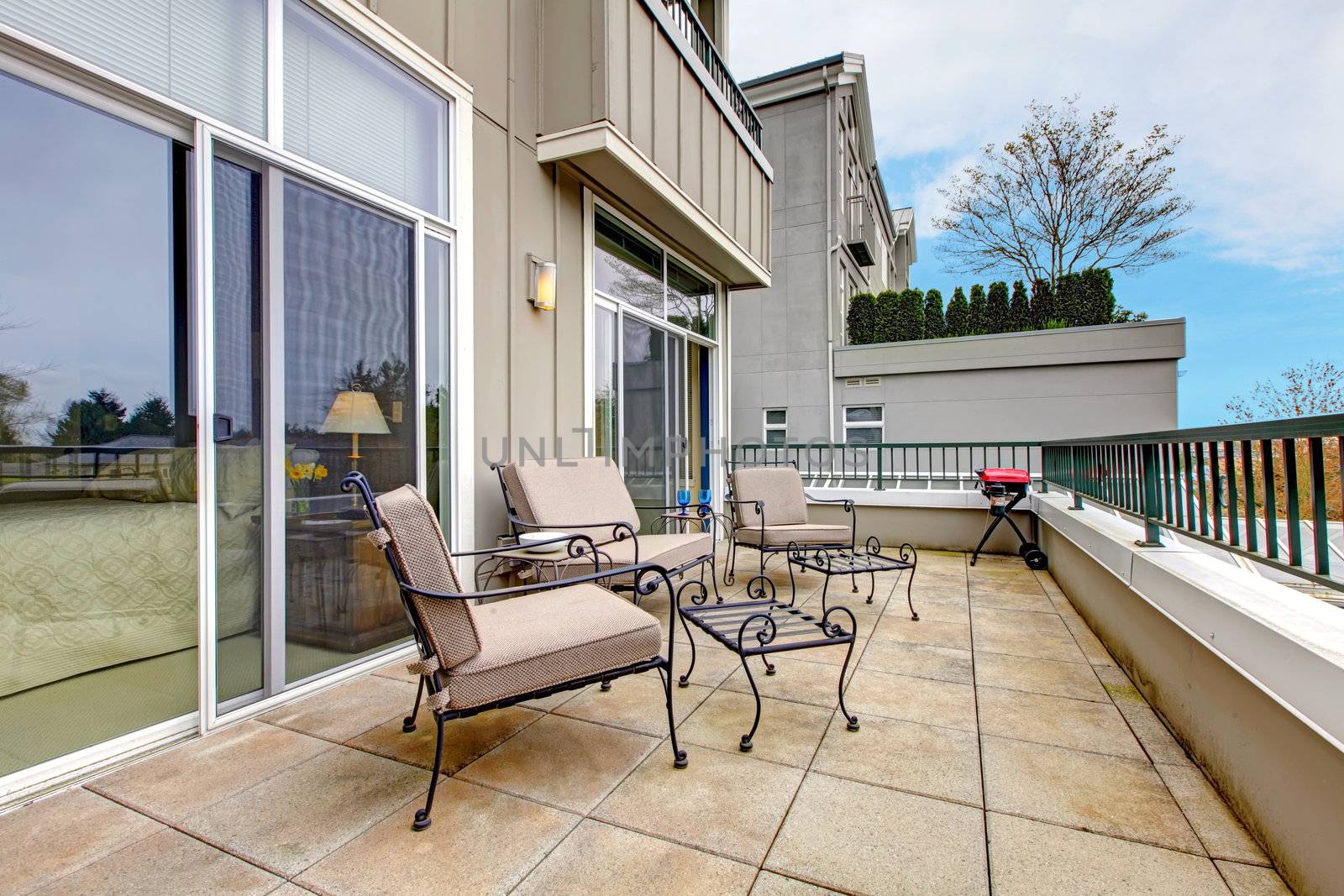 Balcony, large terrace with furniture in new apartment building.