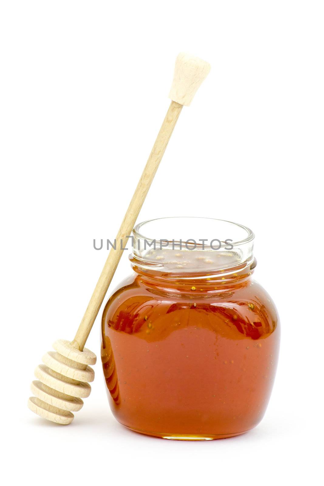 jar of honey and wooden dripper isolated on white by miradrozdowski