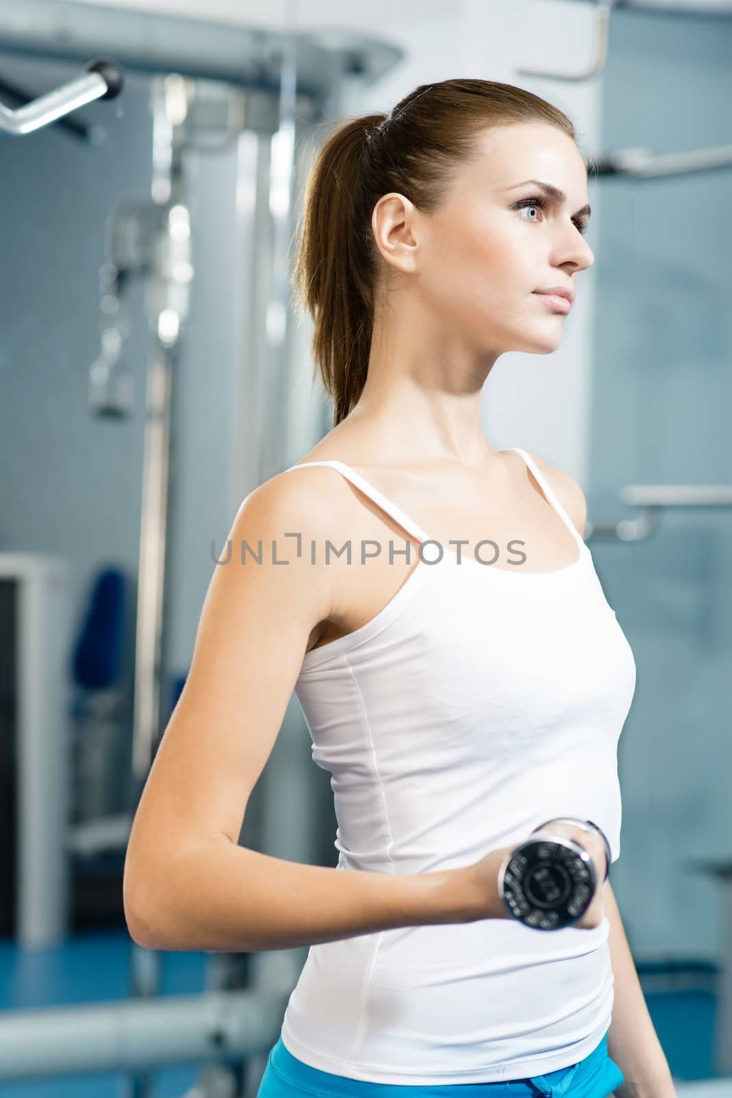 female athlete dumbbell, exercise in the fitness club