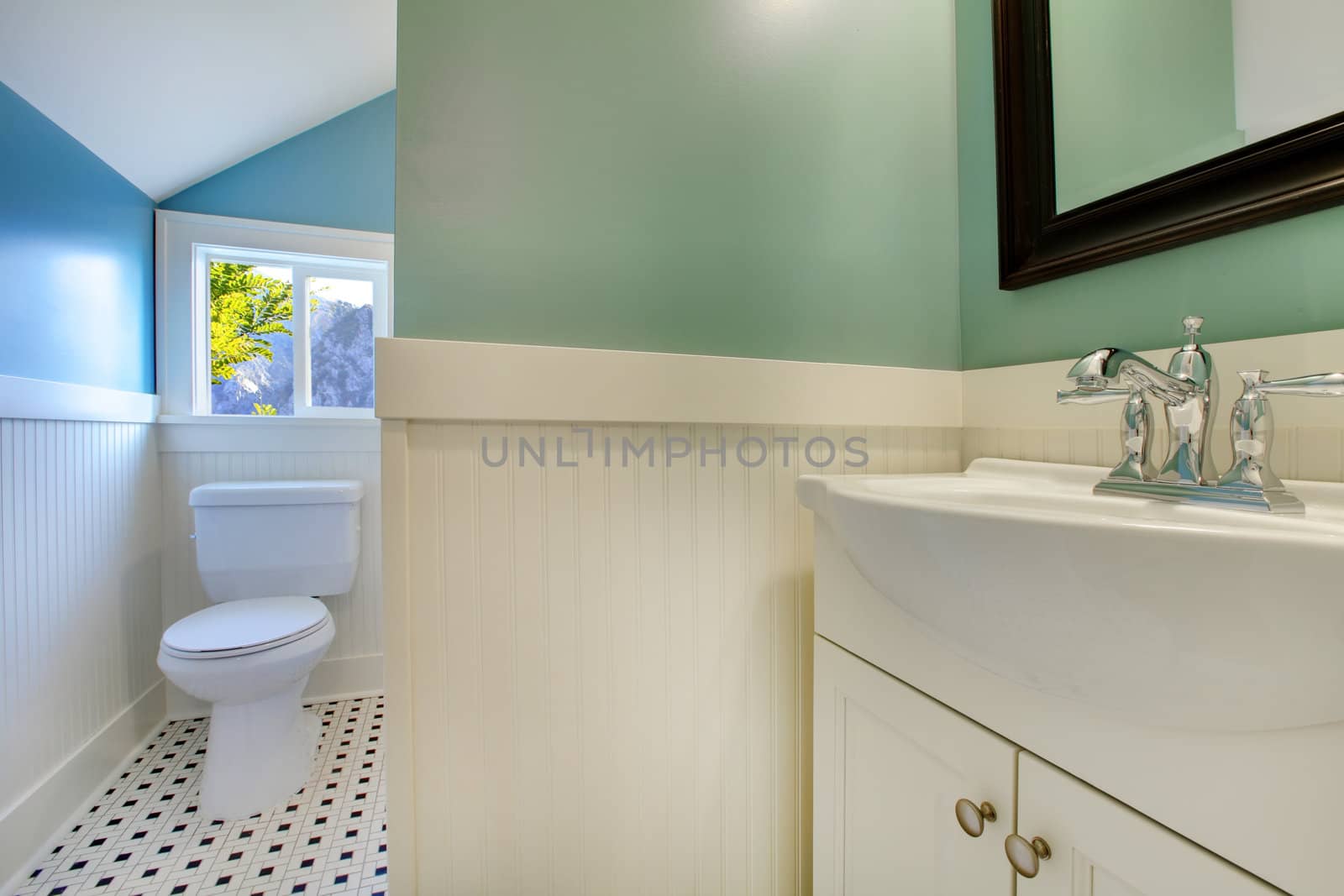 Luxury bathroom with white tiles and blue walls.