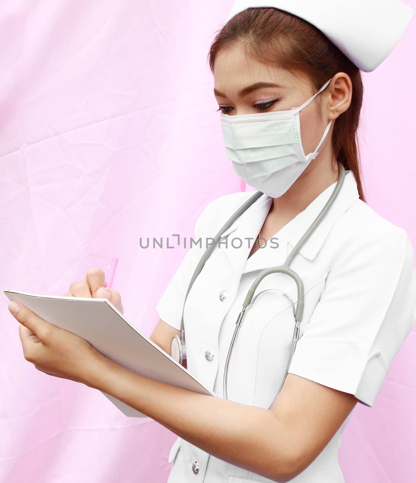 Asian female nurse writing medical report