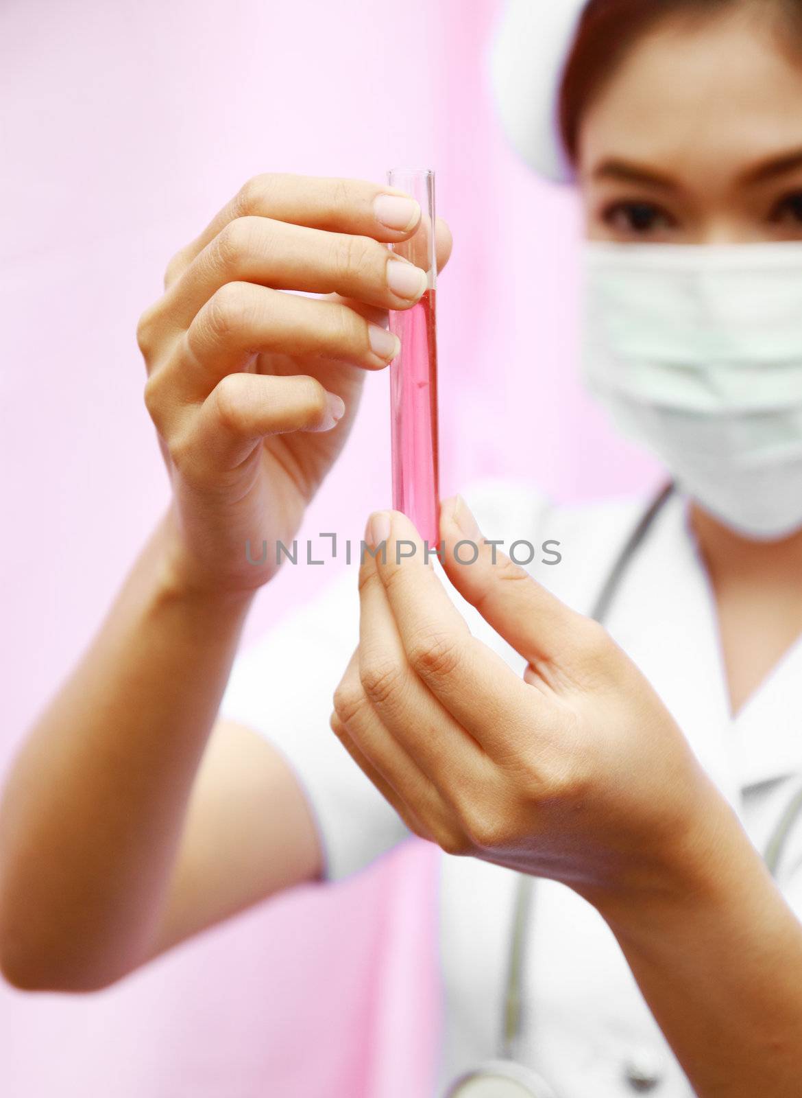Close up of test tube with female nurse