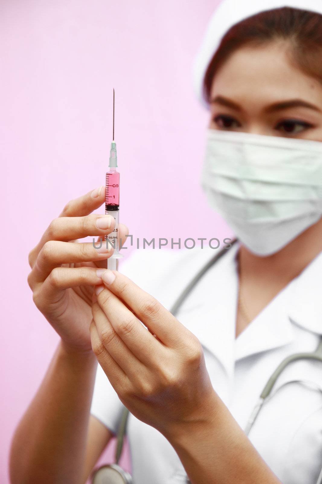 Female nurse standing with syringe