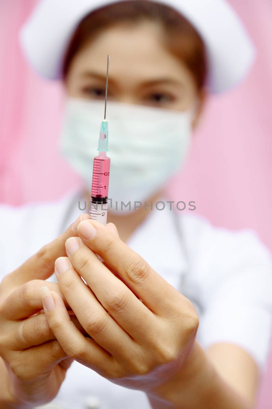Nurse standing with syringe by geargodz