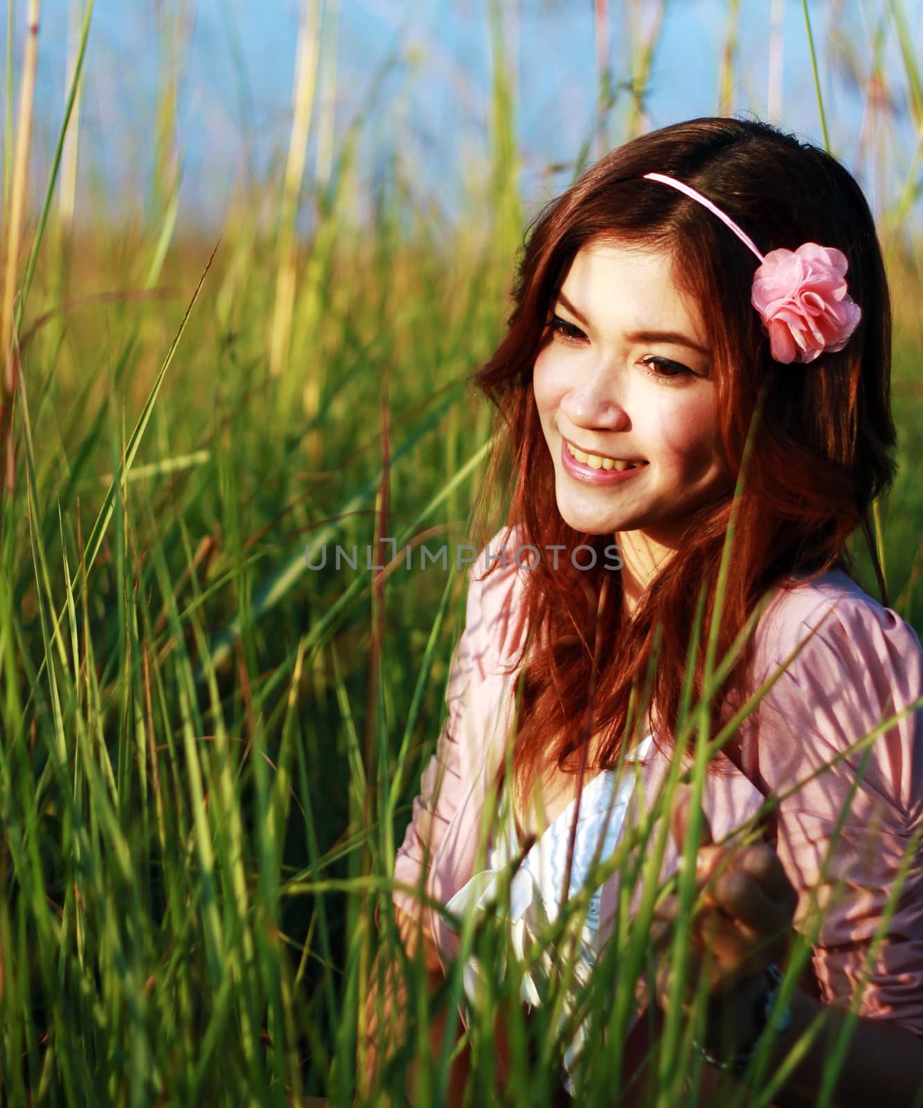 Portrait of beautiful young Asian girl in the grass