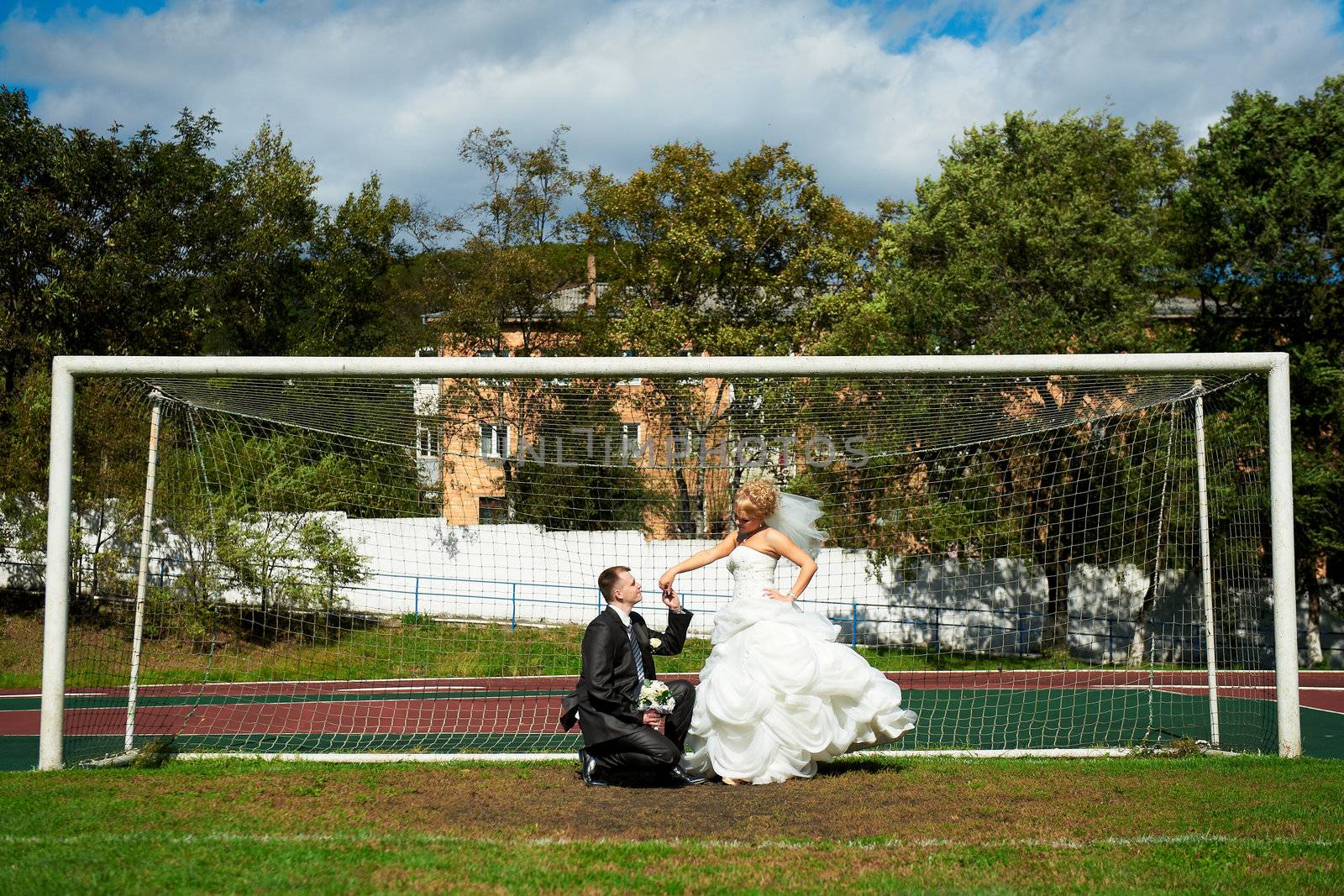 Bride and groom on the football field